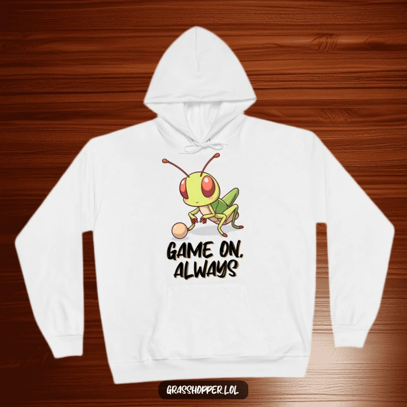 Funny kawaii grasshopper with a determined expression, bouncing a small ball, featured on a warm and cozy hoodie.