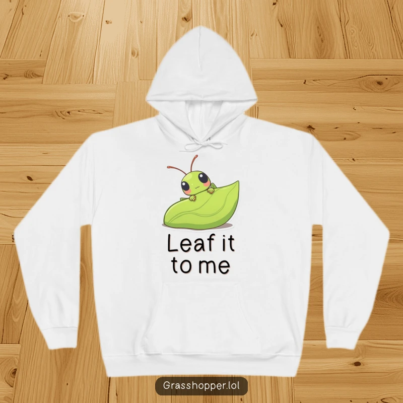 Funny kawaii grasshopper peeking from behind a large leaf, a cute and endearing design on this cozy hoodie.